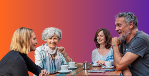 four people around a coffee table listening and building their business relationships
