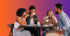 Four happy people laughing and having coffee - showing how business networking can help peoples mental health