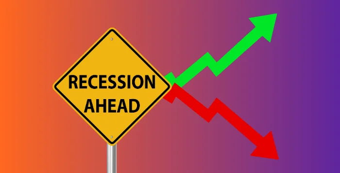 a sign reading recession ahead with two arrows representing and increase and a decrease in profit