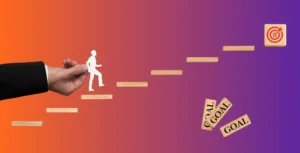 Person walking up stairs made out of blocks that say goals on them towards a target block